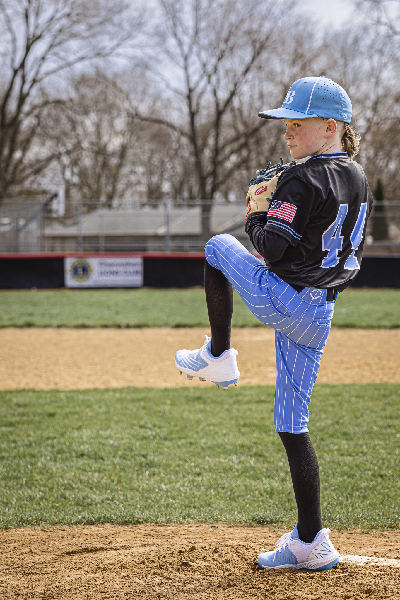 Boy in baseball uniform pitching to his dad at Channahon Pony Baseball Fields in Channahon, IL