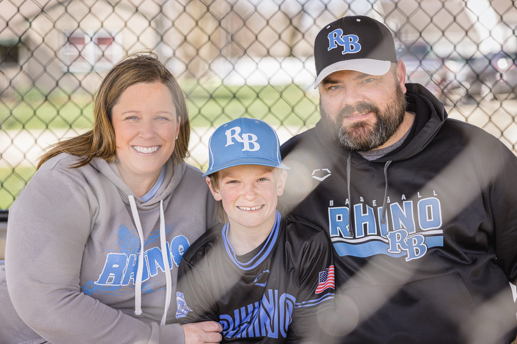 Mom, dad and son having a good laugh in the dug out at Channahon Pony baseball fields in Channahon, IL