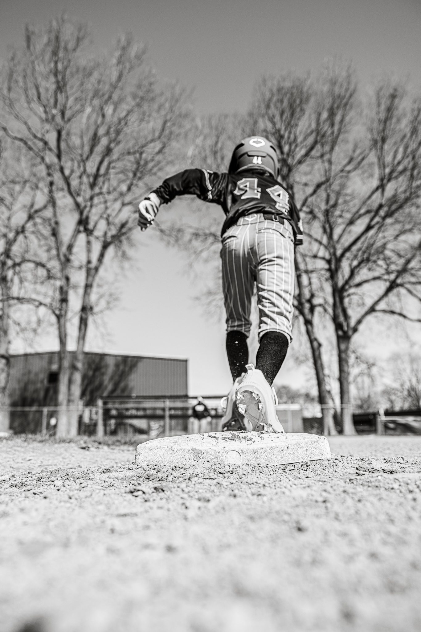 Black and white picture of boy running from 2nd base to third base at Channahon Pony Baseball Field in Channahon, IL