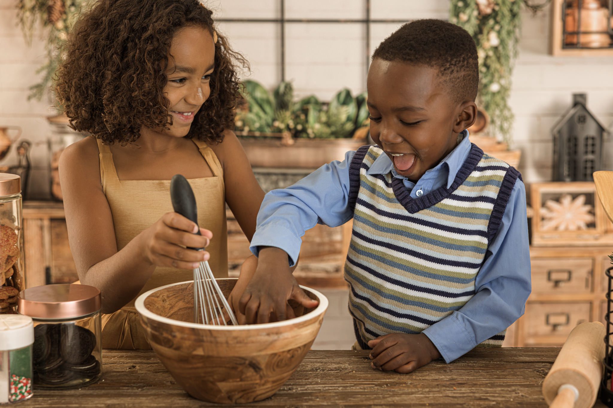 Brother and sister mixing flower during a cookie making photo session for holiday minis. Photo was taken in Warrenville, IL